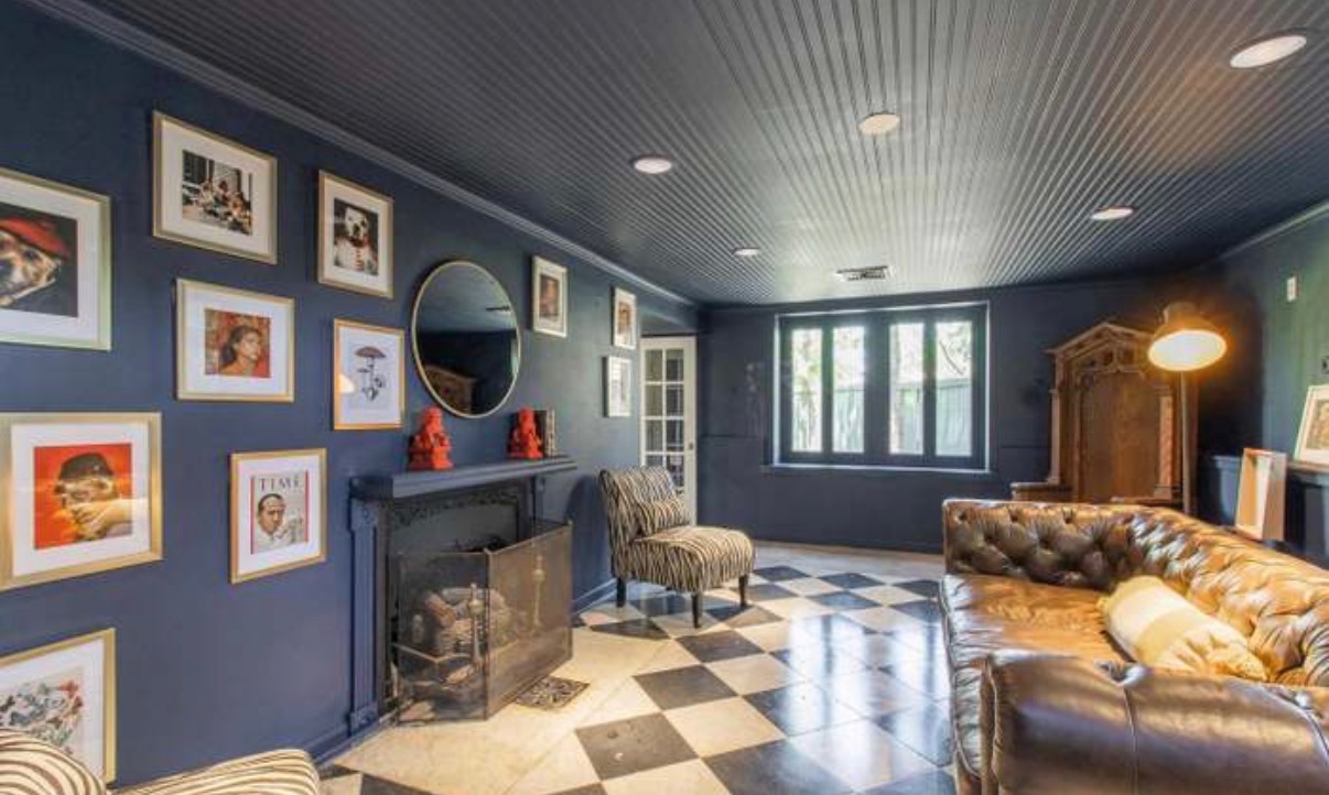 Navy library lounge with checkerboard marble floor and chesterfield sofa