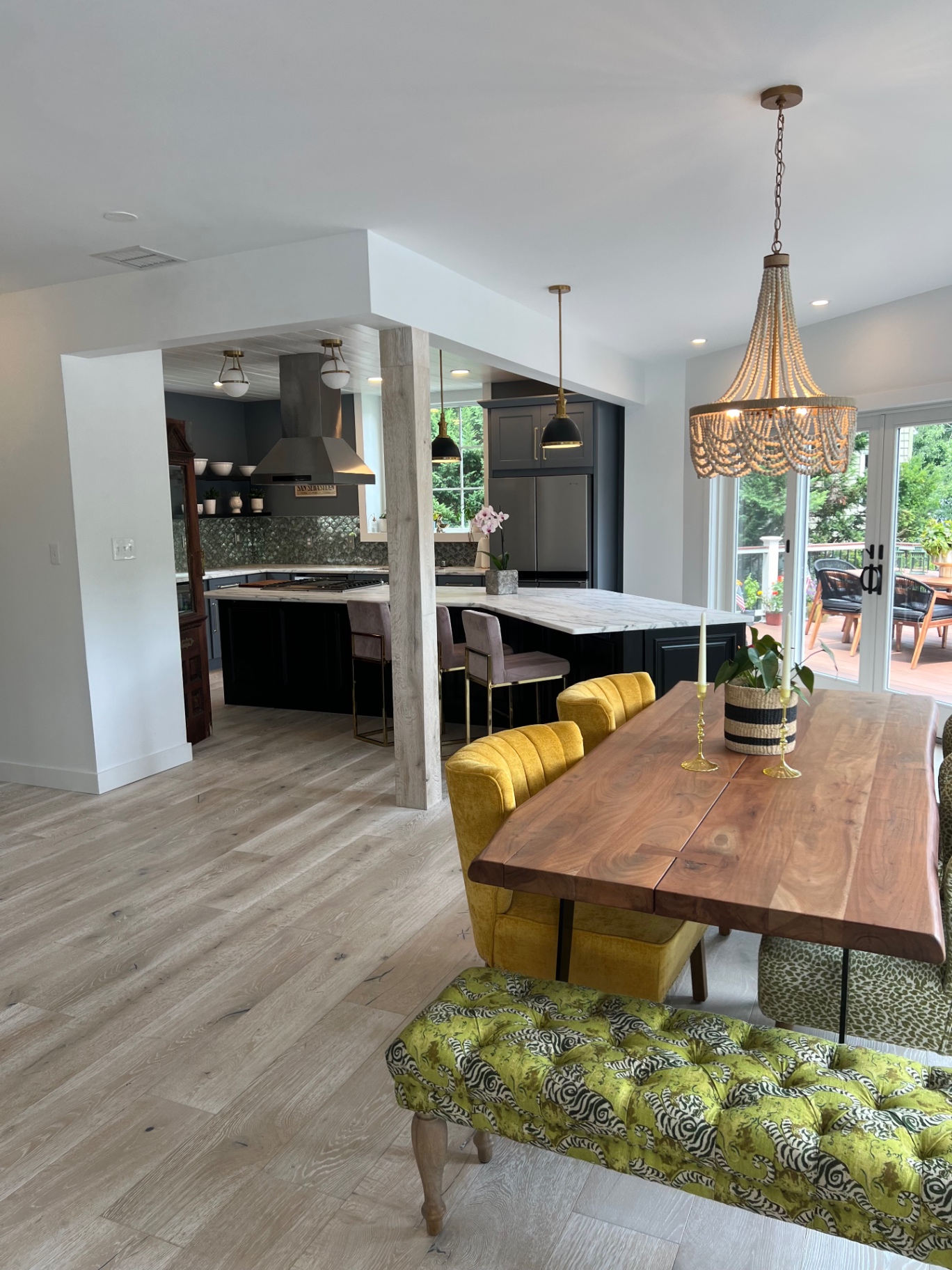 Dining room with chartreuse bench and beaded chandelier